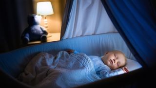Child sleeping in cot at night