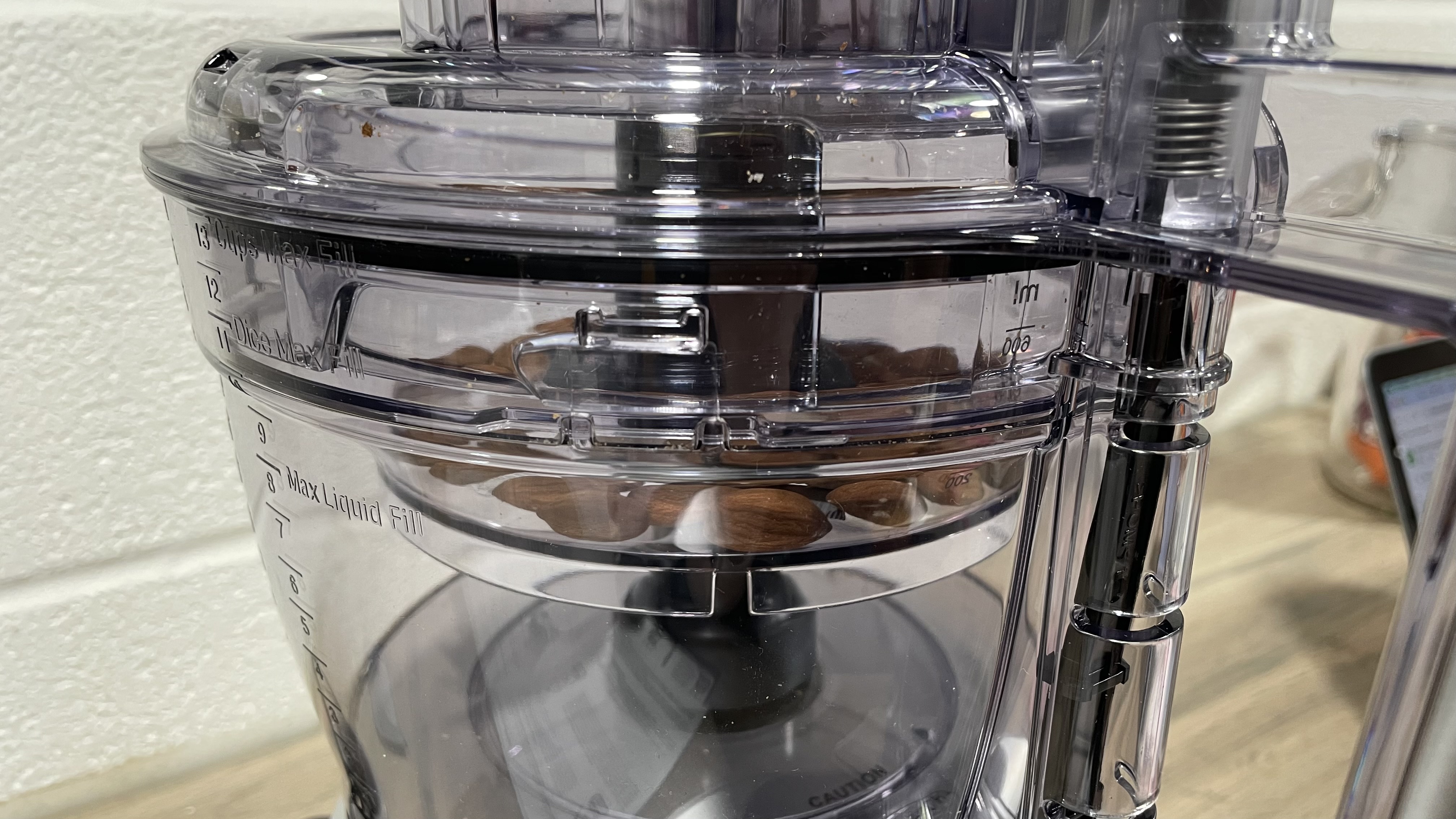 A close up view of almonds inside the smaller work bowl of the Cuisinart Expert Prep Pro.