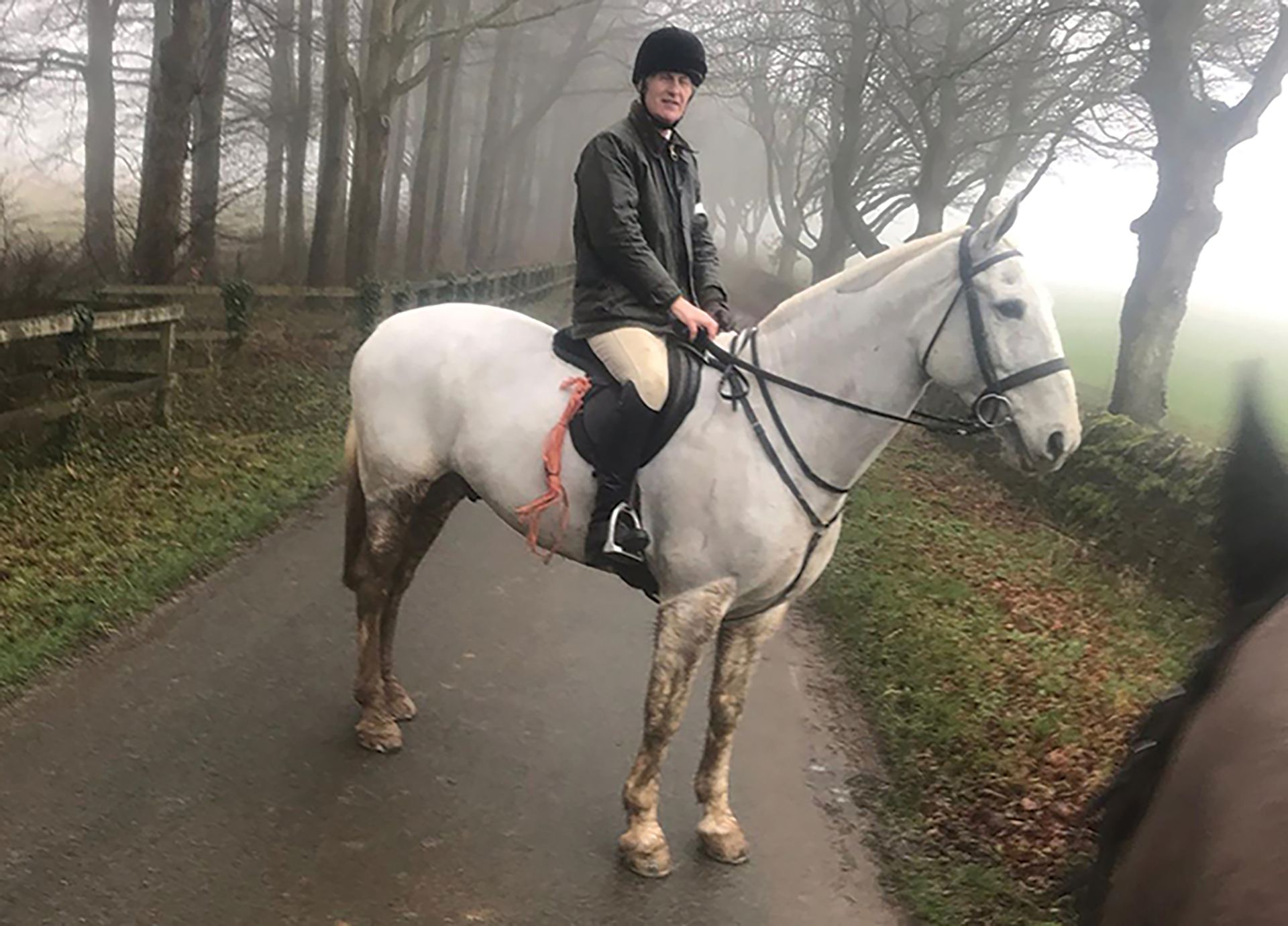Jonathan Hull on gate shutting duty while trail hunting riding grey horse Mr P