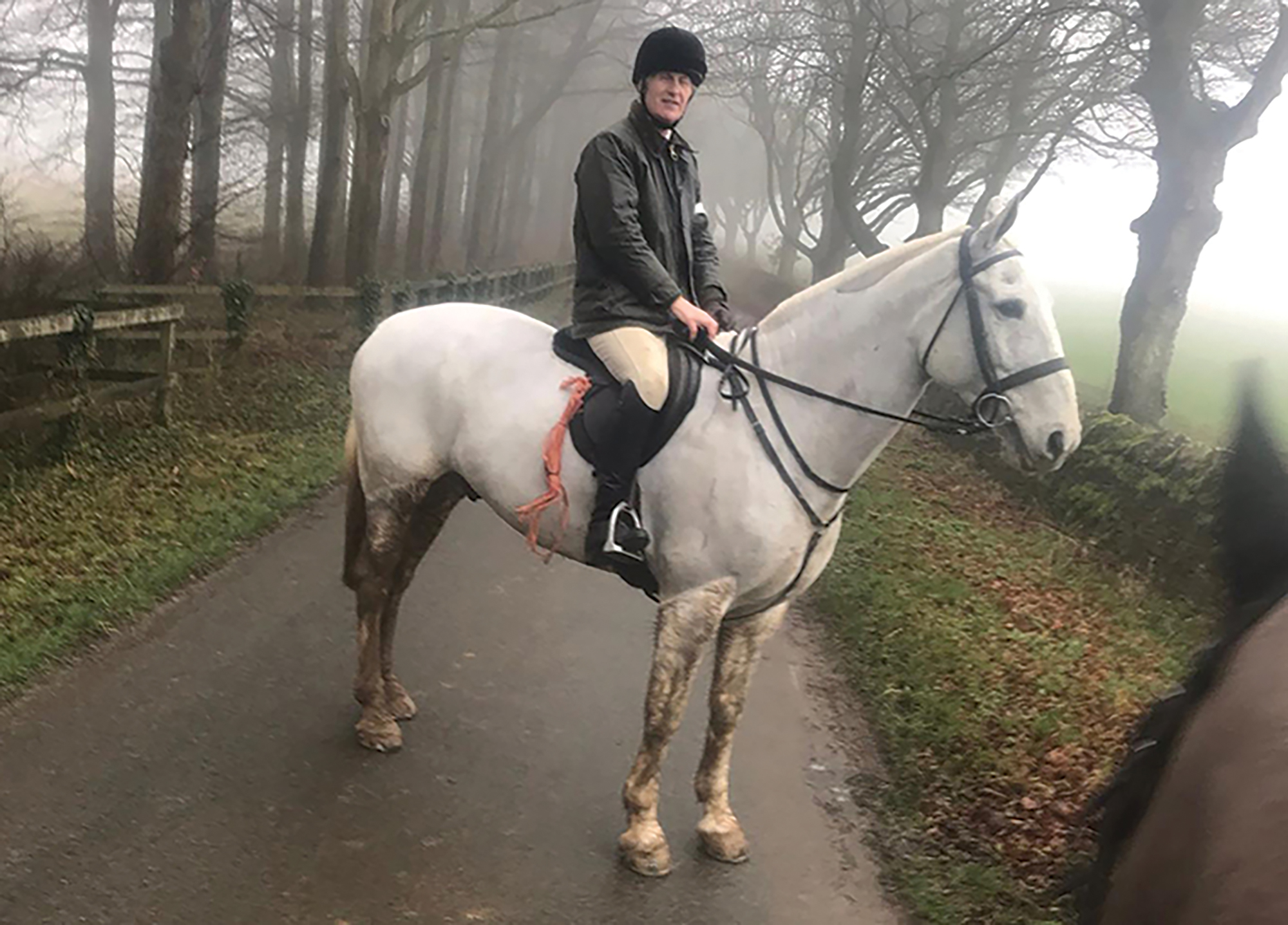 Jonathan Hull on gate shutting duty while trail hunting riding grey horse Mr P
