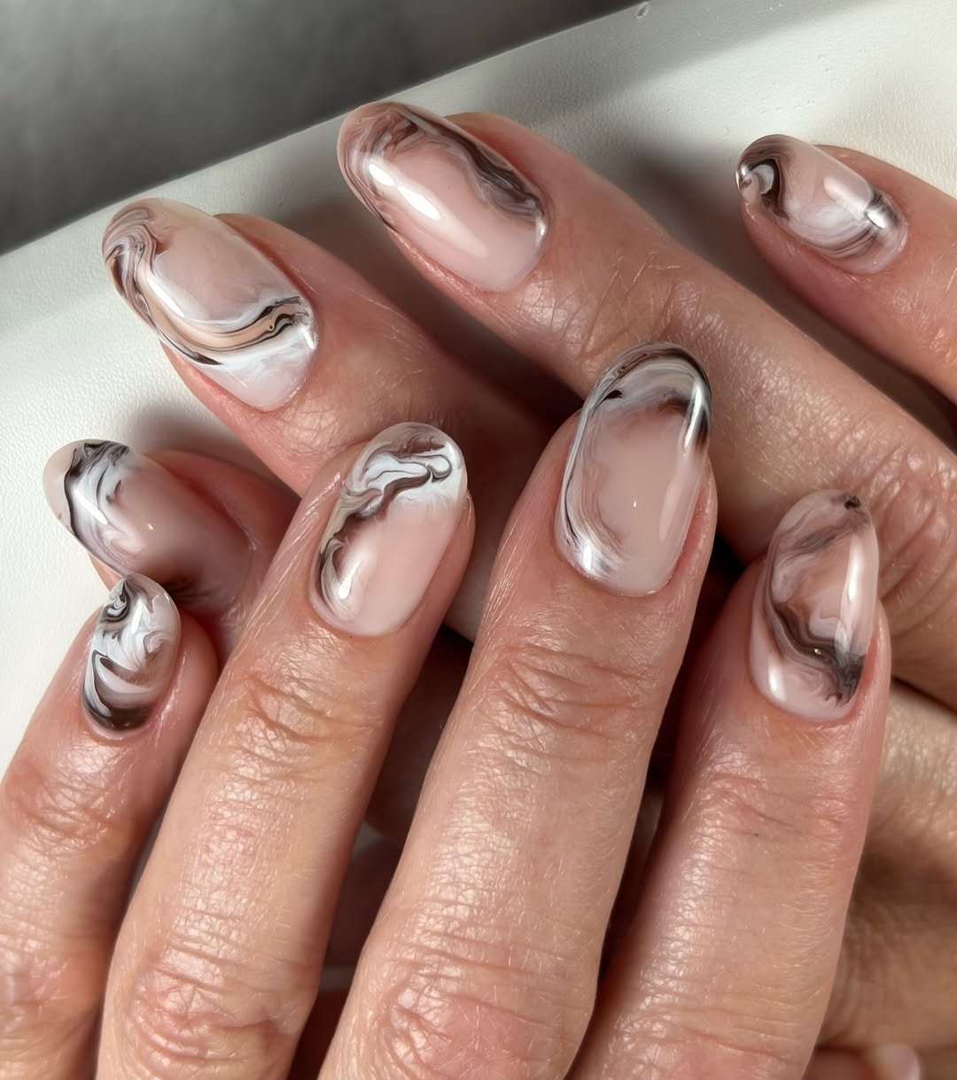 swirled brown and white oval nails