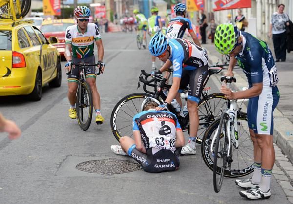 Garmin-Sharp's Robbie Hunter and Tom Danielson come to the assistance of teammate Tyler Farrar, who crashed in the finale of stage 5.