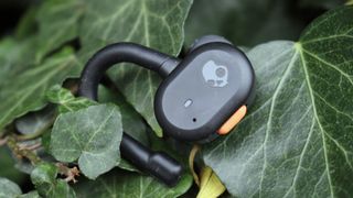 Skullcandy Push Active earbud on some leaves