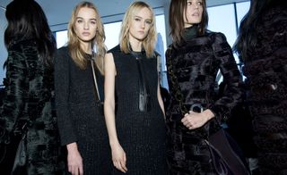 Calvin Klein models wearing black dresses