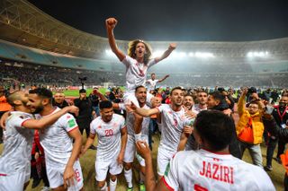 Tunisia players celebrate qualification for the 2022 World Cup after a win over Mali at the Hamadi Agrebi Stadium in March 2022.