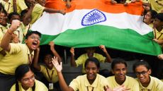Schoolchildren celebrate the successful landing of the Indian spacecraft 