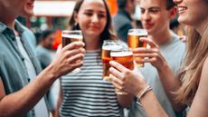 Group of youngsters enjoying a beer outside