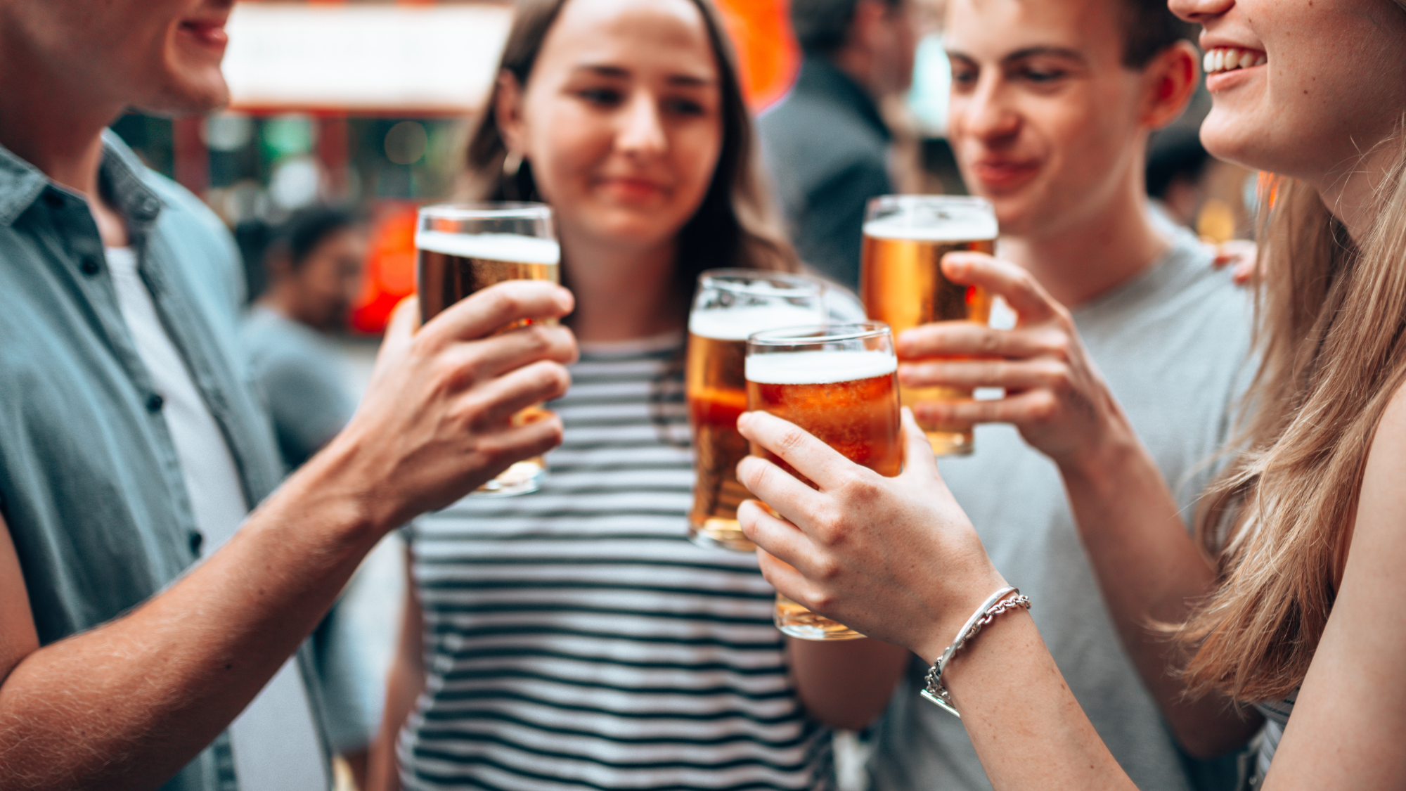 Group of youngsters enjoying a beer outside