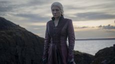 Queen Rhaenyra stands stoically alone on a shoreline in House of the Dragon season 2