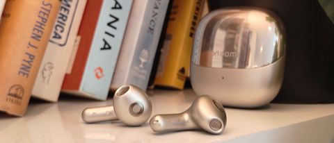 The Xiaomi Buds 5 on a bookshelf.