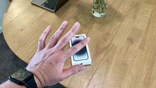 Hand waving goodbye to an iPhone 14 Pro