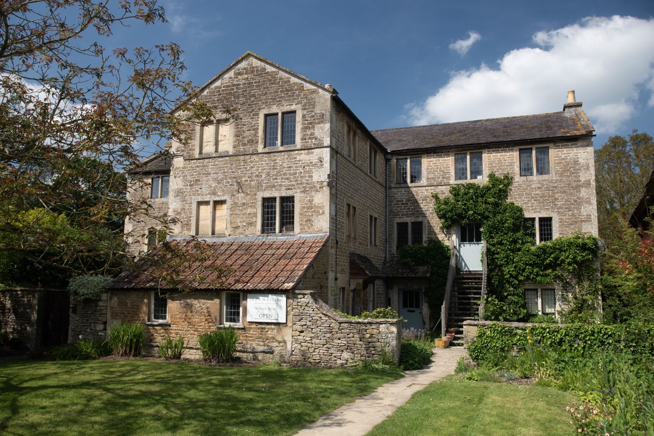 An image of a country home and garden with a blue sky