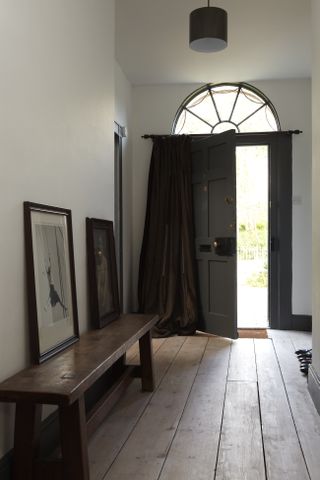 Inside of hallway with a grey painted inside of front door