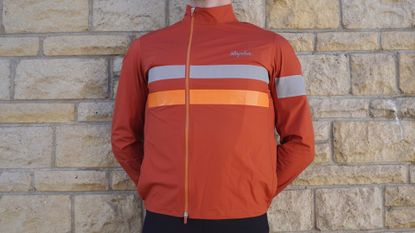 Image shows a rider wearing the Rapha Brevet Gore-Tex Rain Jacket