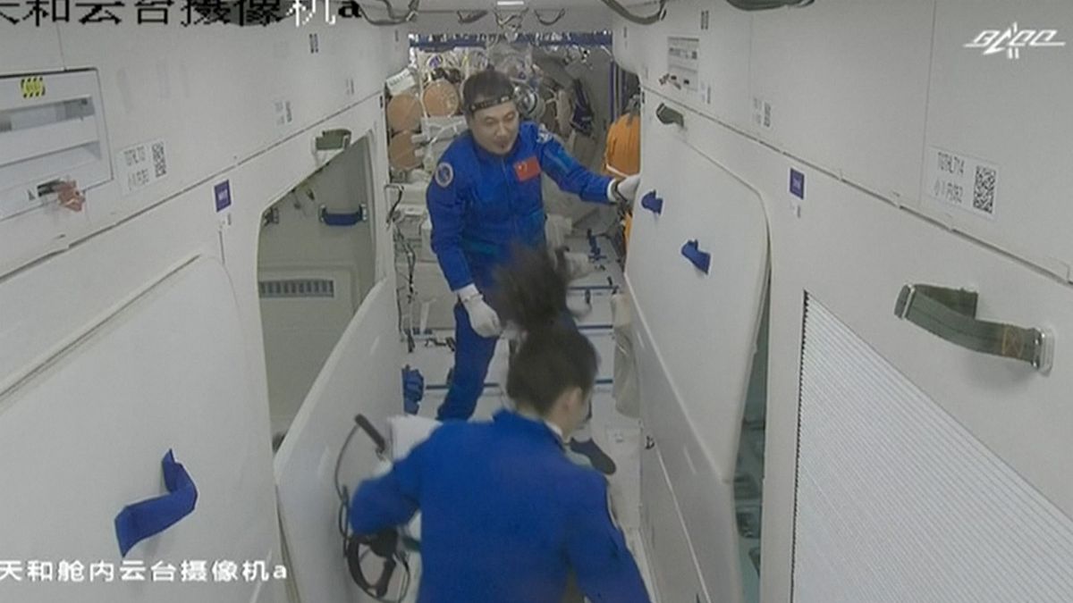 China's Shenzhou 13 astronauts float inside the Tianhe core module of the country's Tiangong space station after a successful docking on Oct. 16, 2021.