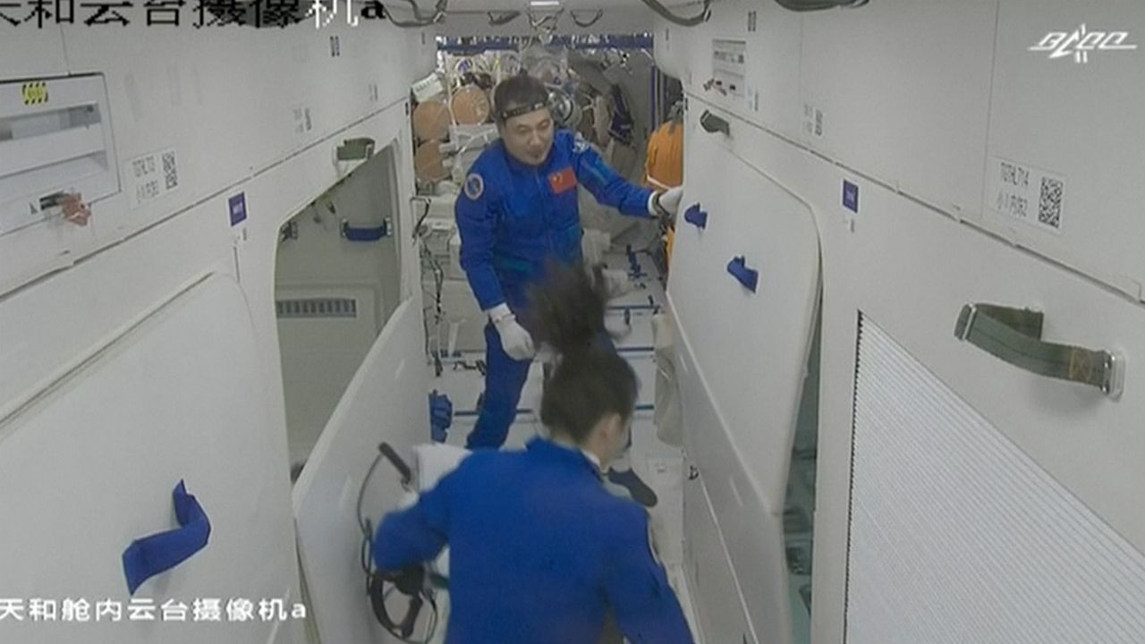 China's Shenzhou 13 astronauts float inside the Tianhe core module of the country's Tiangong space station after a successful docking on Oct. 16, 2021.