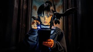 Wednesday Addams shines a torch on an item in her self-titled Netflix series