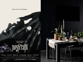 Nosferatu movie poster and a dining room scene with black walls, table, and furniture