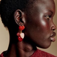 a model wearing heart earrings from sezane