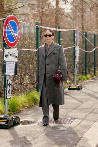 Guest wearing a gray oversize coat with matching trousers in Milan.