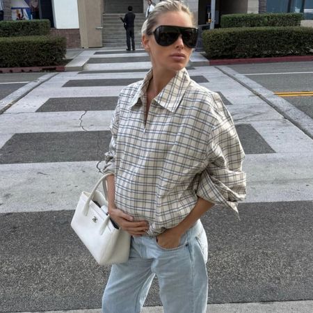 Elsa wears a plaid jacket, white chanel bag, and low rise jeans.