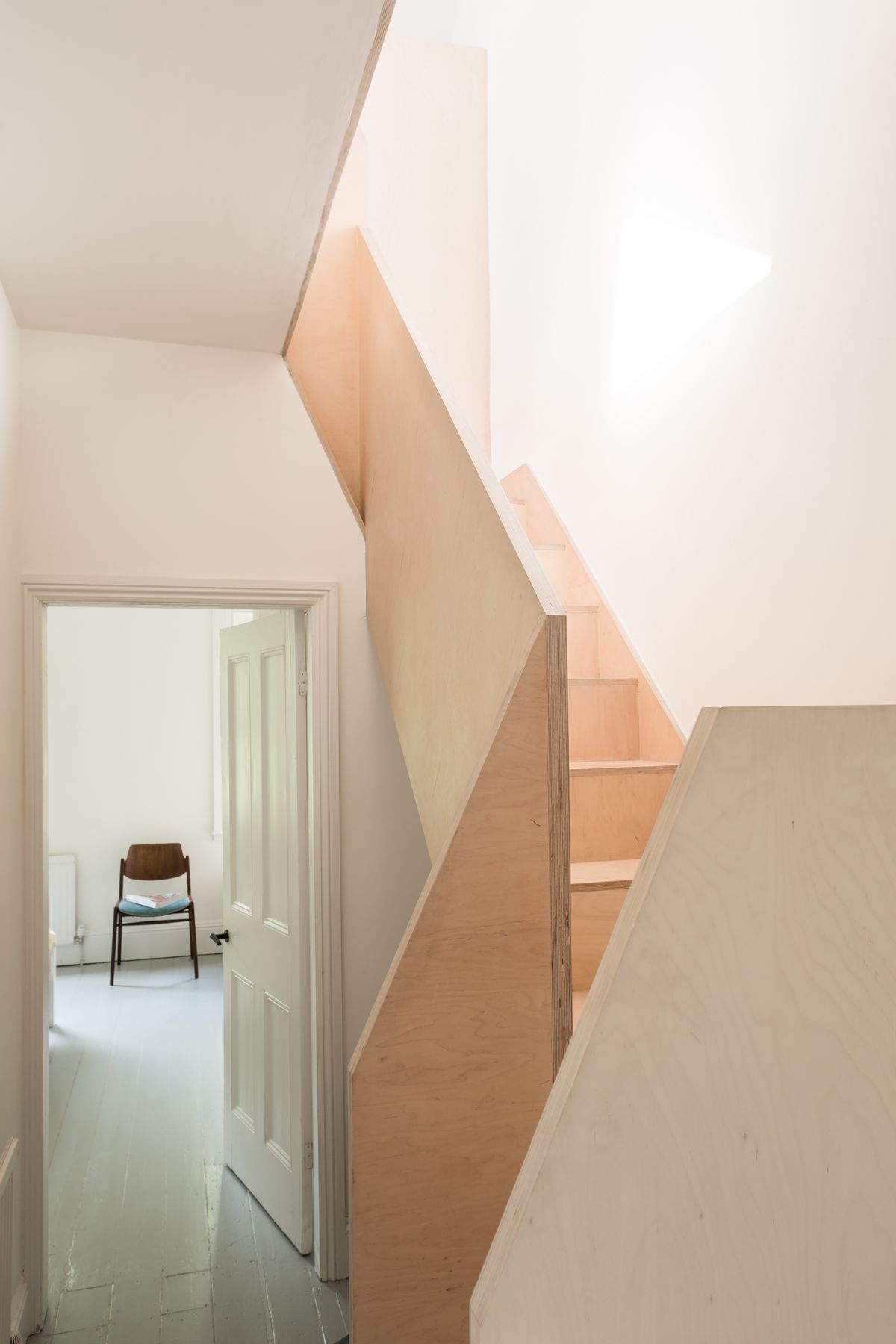 plywood staircase in renovated victorian hallway