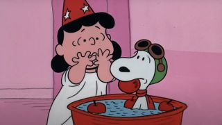 Lucy stands with a worried expression while Snoopy holds an apple in his mouth in It's The Great Pumpkin, Charlie Brown.