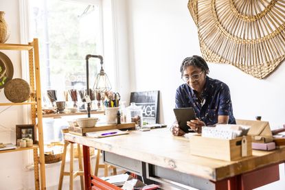 small business owner using smartphone in her store