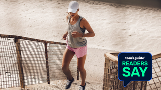 A fit woman running up stairs with cap on