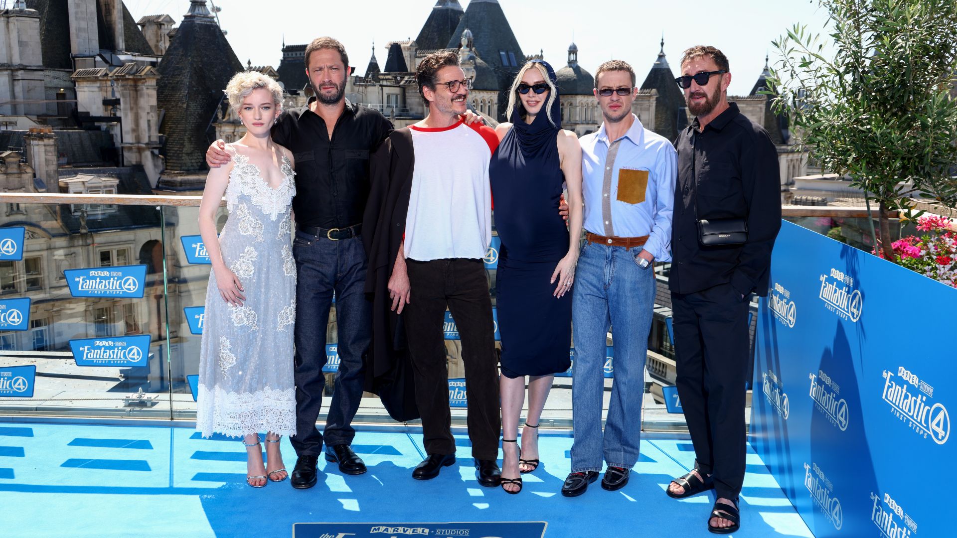 an image of the Fantastic Four: First Steps cast. From left to right, it is Julia Garner, Ebon Moss-Bachrach, Pedro Pascal, Vanessa Kirby, Joseph Quinn, and Ralph Ineson