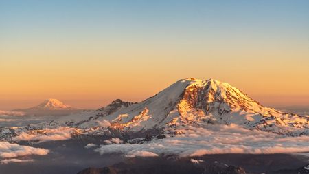 The Cascade Range extends from southern British Columbia in Canada through Washington, Oregon and northern California in the United States. The highest peaks, called the High Cascades, are volcanoes. Mount Baker, seen in the foreground here, is one of the tallest peaks in the range. Mount Rainier, seen in the background, is the tallest peak in the Cascades.