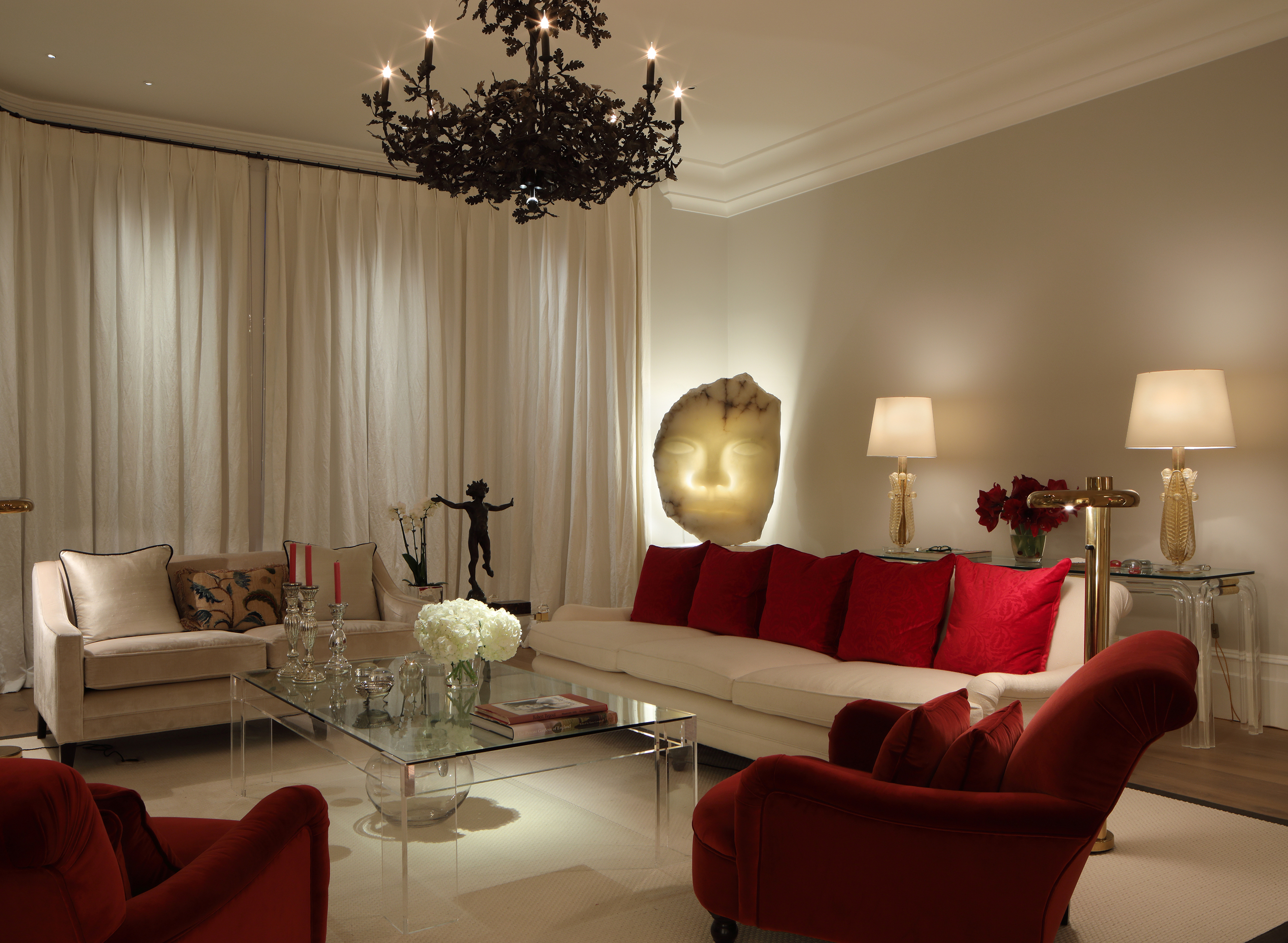Sculpture backlit by John Cullen Lighting in a cream and red colored living room