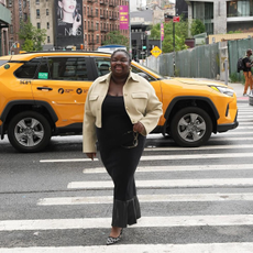 @abimarvel wearing a long black dress and cropped jacket