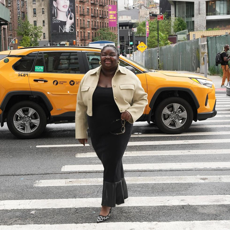 @abimarvel wearing a long black dress and cropped jacket