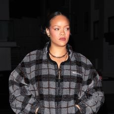 Rihanna wearing the Miu Miu Checked Teddy Jacket with track pants and snakeskin boots