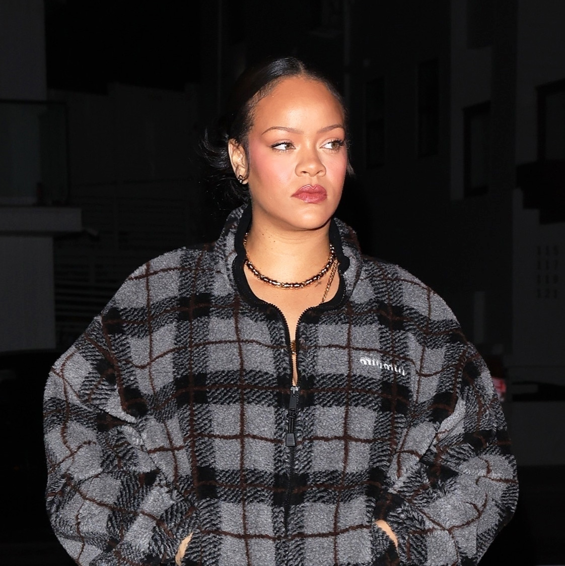 Rihanna wearing the Miu Miu Checked Teddy Jacket with track pants and snakeskin boots