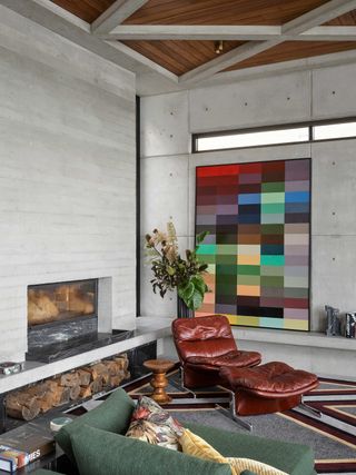 a brutalist living space with color and retro furniture