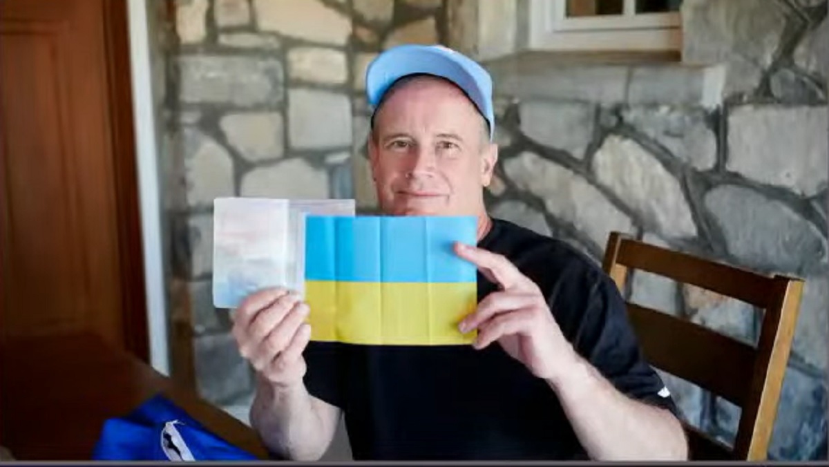 Blue Origin NS-20 space tourist Jim Kitchen shows the small Ukrainian flag and passport he used to visit the country. Kitchen took both items to space on Blue Origin's New Shepard rocket on March 31, 2022 to show support for Ukraine amid Russia's invasion.