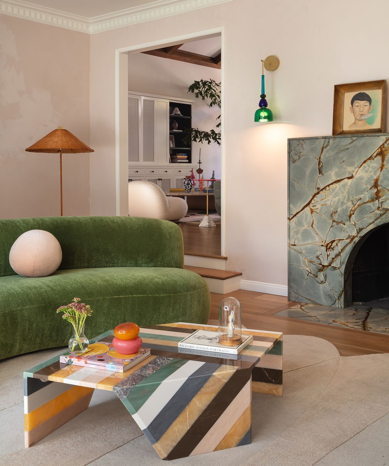 living room with green sofa and striped coffee table