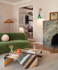 living room with green sofa and striped coffee table