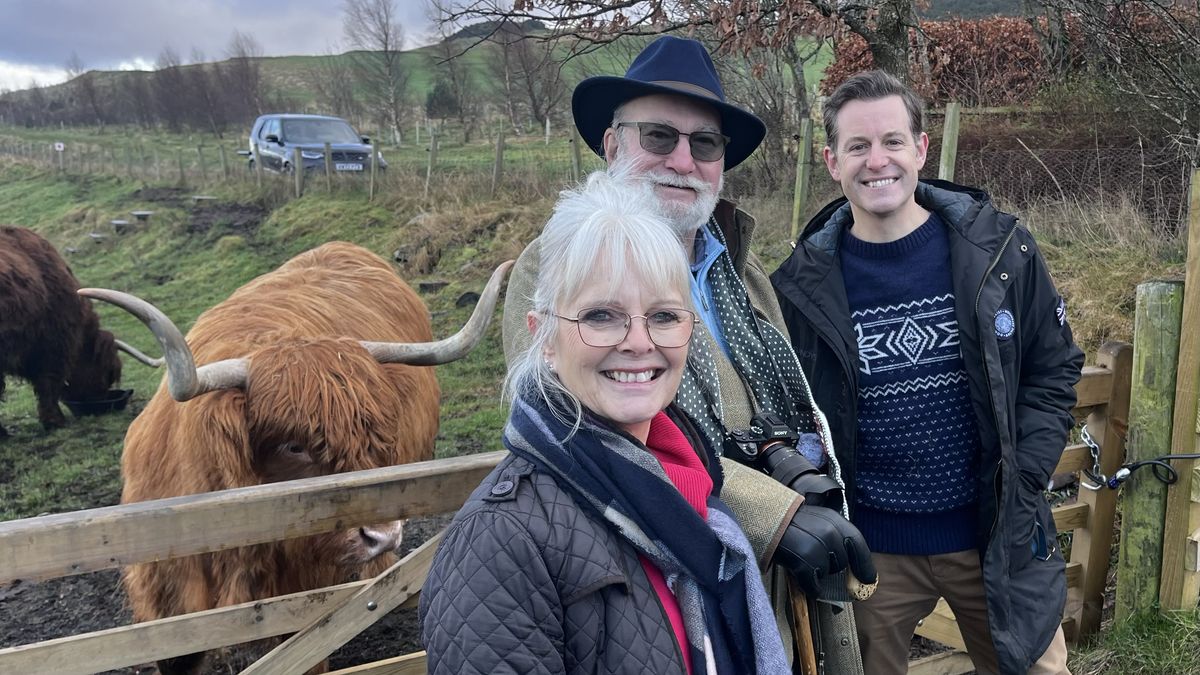 Matt Baker: Christmas Travels with Mum and Dad image of Matt with his parents and a highland cow in a winterly landscape. 