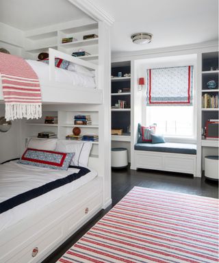 Red, blue and white kid's bedroom with bunk beds, desk and shelves