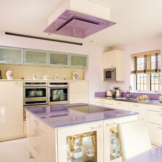 white kitchen with purple countertop and white flooring