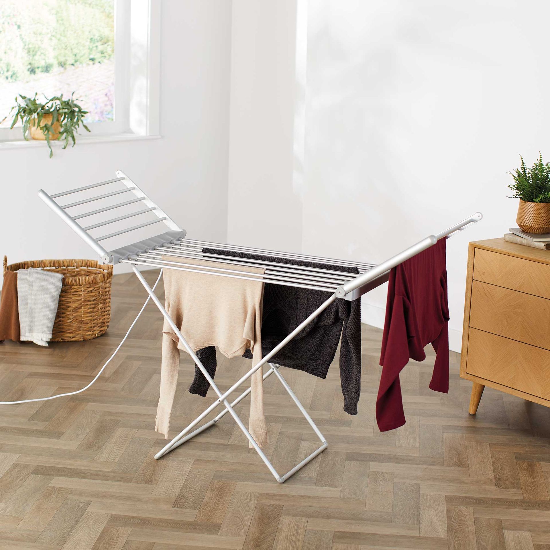 Aldi winged heated clothes airer in a white kitchen being used to dry clothes