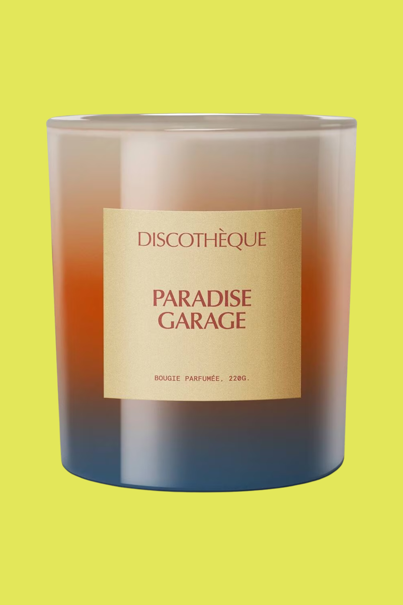 A scented candle in a colorful gradient glass vessel