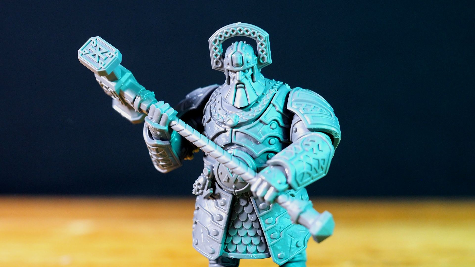 A Gholem wielding a warhammer against a dark background