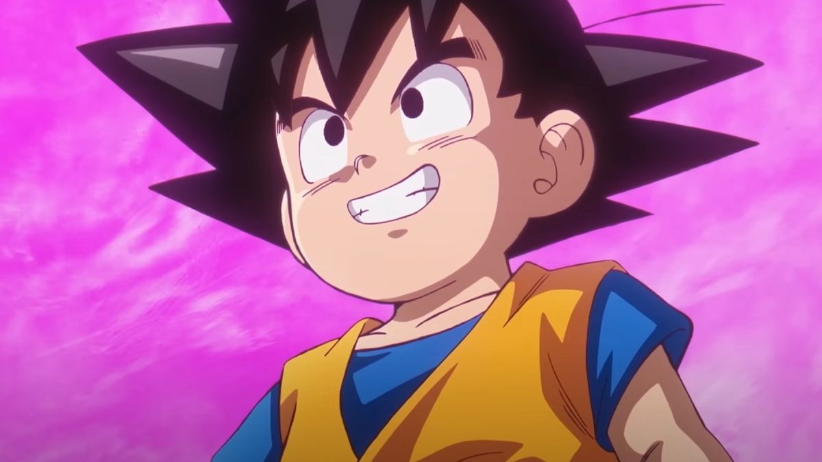 Young Goku smiles in front of a purple sky