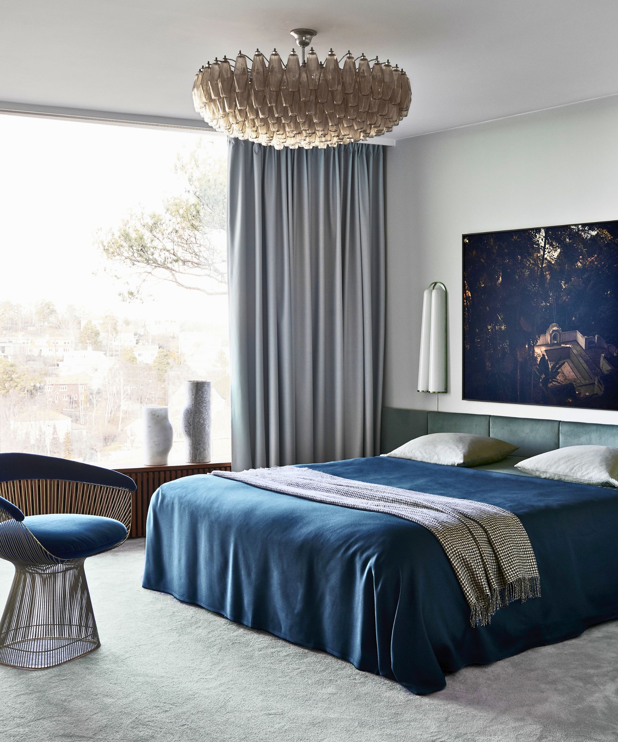 bedroom with blue bedding and statement light white walls