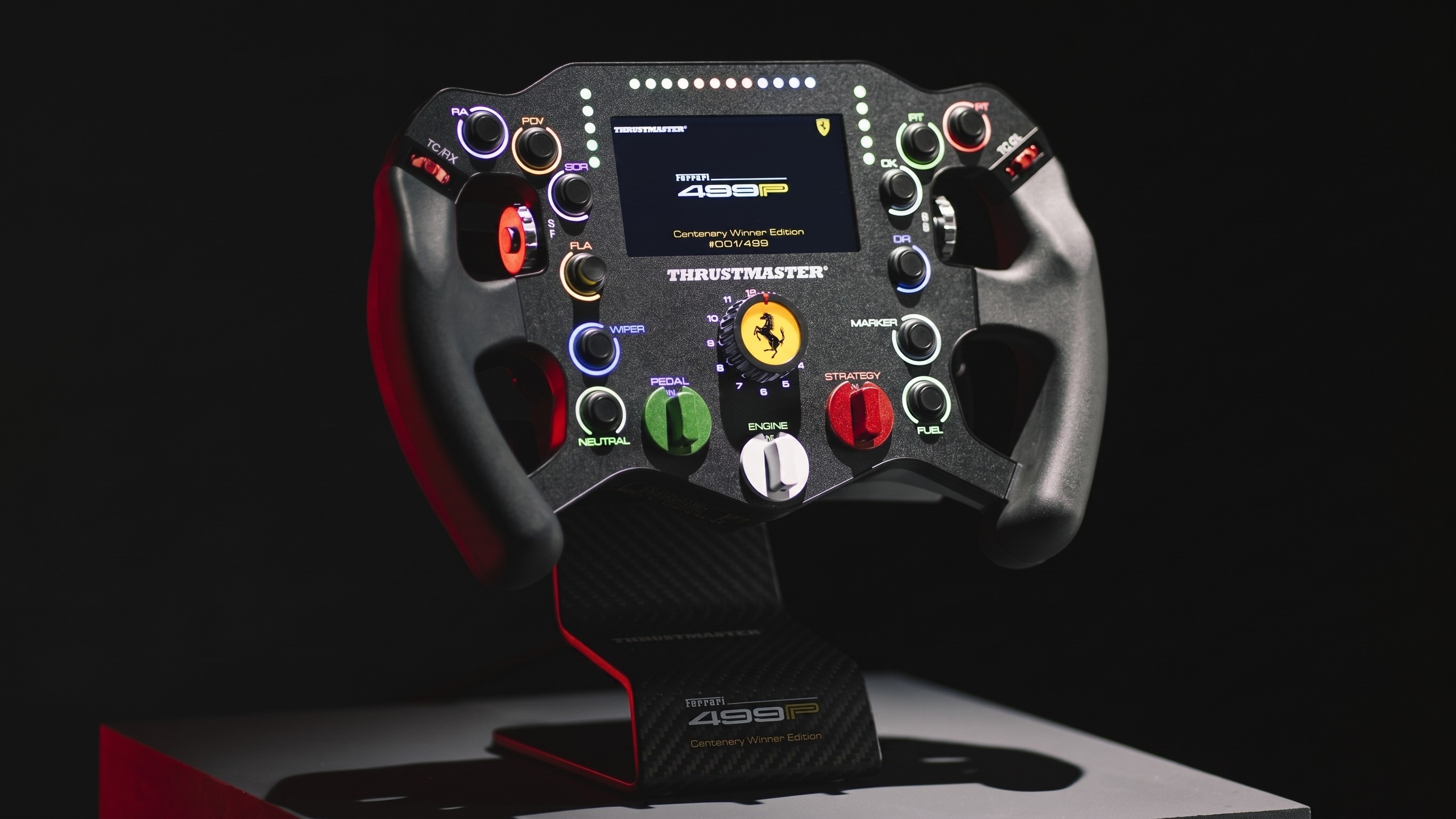 The Thrustmaster 499P Ferrari racing wheel on a display stand.