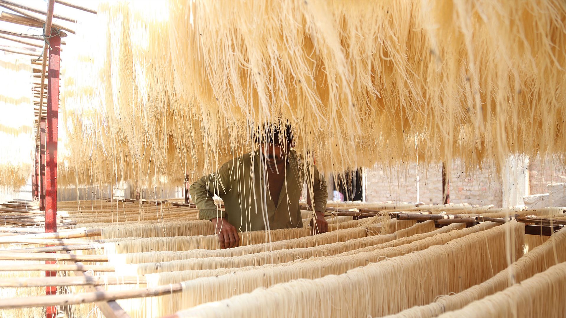 
                                A laborer prepares vermicelli noodles at a workplace in Hyderabad, Pakistan
                            